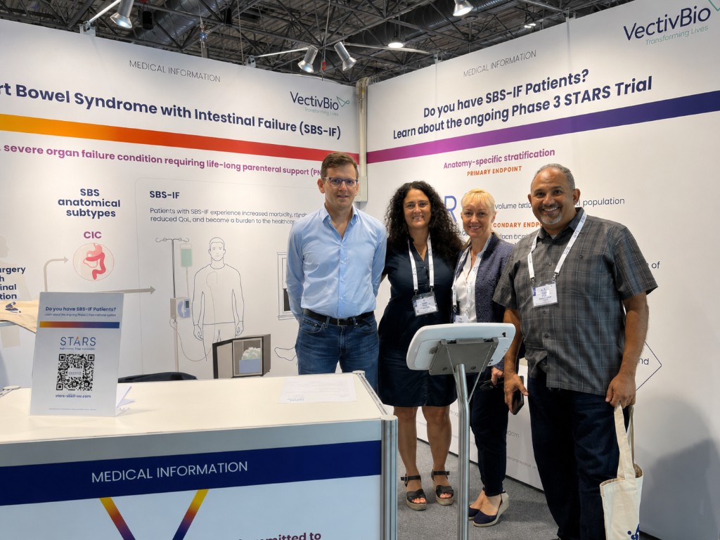 Dr. Youssef with colleagues at a VectivBio medical information booth